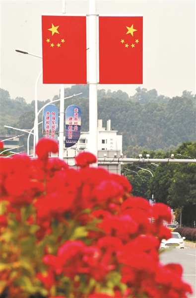 南沙区进港大道和府前路两旁，鲜艳的五星红旗在蓝天下格外夺目。
